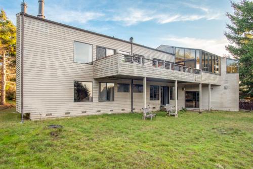 a large house with a large yard in front of it at Riverview - Private Hot Tub - Sleeps 12 in Sea Ranch