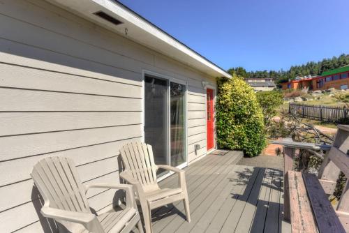 two chairs sitting on the porch of a house at Lucky Ewe - Ocean View Retreat in Gualala