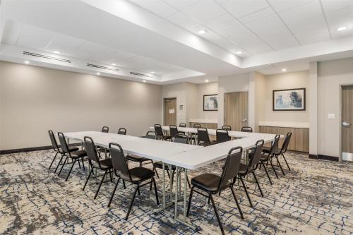 a conference room with a large white table and chairs at Best Western Plus Mid County in Port Arthur