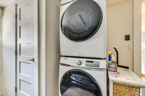 a washer and dryer with a microwave on top of it at Swim, Fish and Relax Port Richey Gem with Yard! in Port Richey