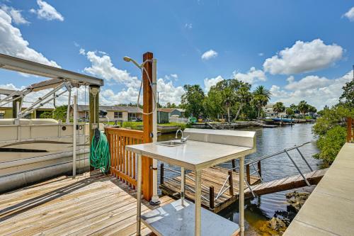 a deck with a sink and a boat at Swim, Fish and Relax Port Richey Gem with Yard! in Port Richey