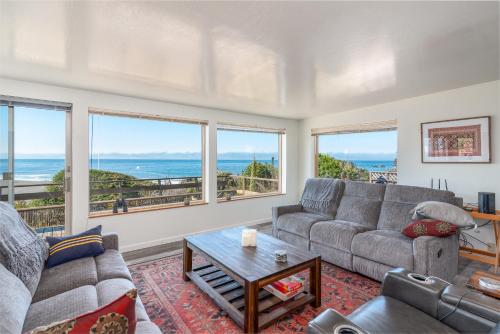 a living room with a couch and a table at Ocean Bungalow - Tesla EV Station & Near Trails in Gualala