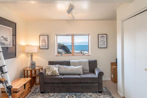 a living room with a couch and a window at Ocean Bungalow - Tesla EV Station & Near Trails in Gualala