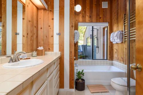 a bathroom with a tub and a sink and a toilet at Charming 3 BD Family Home for 6 with Ocean Views & Trail Access in Sea Ranch
