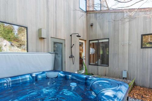 a large blue tub in front of a building at Charming 3 BD Family Home for 6 with Ocean Views & Trail Access in Sea Ranch
