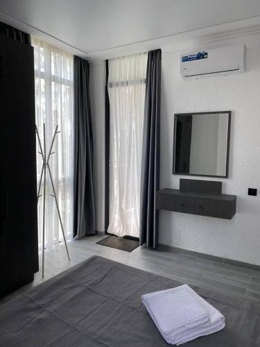 a room with a flat screen tv on a wall at Magnetoria in Urekis Sadguri
