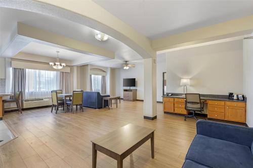 a living room with a couch and a table at Best Western Firestone Inn & Suites in Longmont