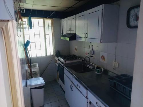 a small kitchen with a sink and a stove at Cabaña brisa melgar in Melgar