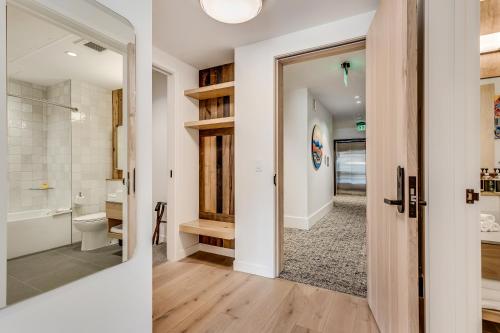 a bathroom with a shower and a toilet and a doorway at Electric Pass Lodge by Snowmass Vacations in Snowmass Village