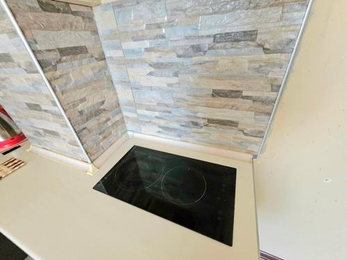 a corner of a room with a stone wall at apartment Leyla in Batumi