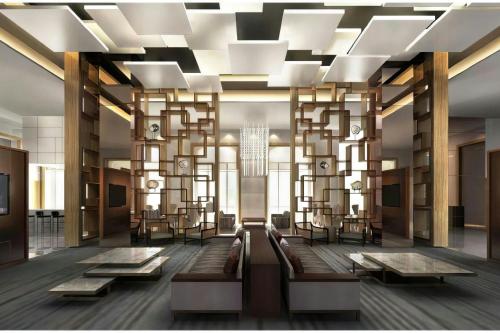 a lobby with a large chandelier and tables and chairs at Sheraton Nouakchott Hotel in Nouakchott