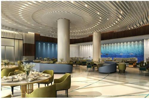 a rendering of a restaurant with tables and chairs at Sheraton Nouakchott Hotel in Nouakchott