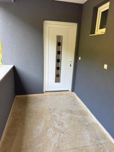 a room with a white door and a tile floor at APARTMAN Visoko in Visoko