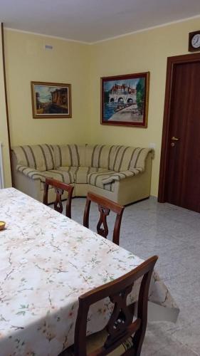 a living room with a couch and a table at Dimora i Mandorli 2 in Colonnella