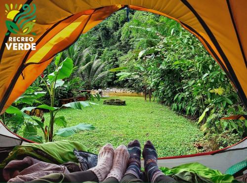a pair of feet in a tent looking at a forest at Recreo Verde Hot Springs & Spa in Marsella