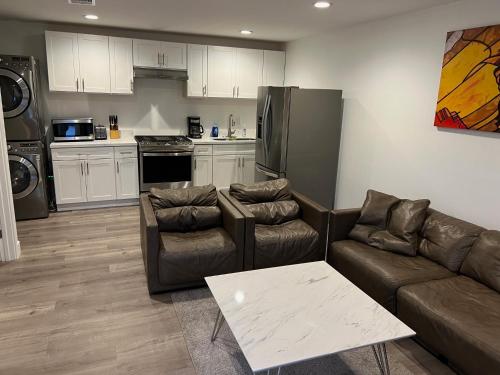 a living room with two couches and a kitchen at Brand new private one bed one bath home with private parking for 2 in Van Nuys Airport