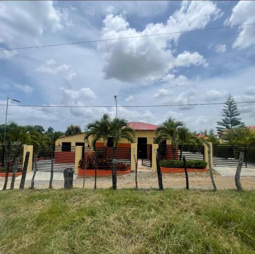 a house with a fence in front of it at Rancho La Loma in Higuey
