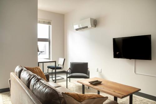 a living room with a couch and a table at Deer District Studio Apt - One Block from Fiserv and Baird in Milwaukee
