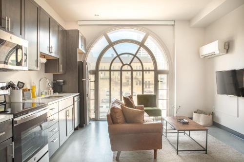 a kitchen with a couch and a table in a room at Deer District Studio Apt - One Block from Fiserv & Baird in Milwaukee