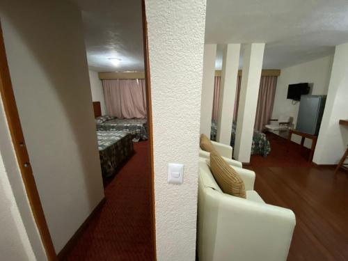a room with a room with a bed and a mirror at Grupo Hotelero Panoramico in Ciudad Victoria