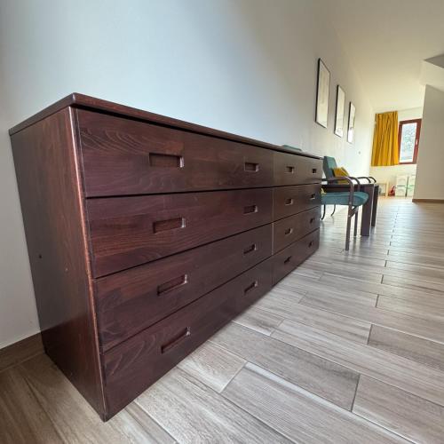 a large wooden dresser in a living room at Vinařský dům V Zahradě in Pasohlávky