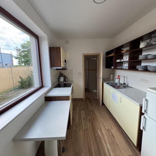 a small kitchen with a window and a sink at Vinařský dům V Zahradě in Pasohlávky