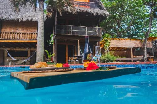 a table with food and drinks on top of a swimming pool at Cabarete Ecolodge Encuentro Surf Beach Kite in Perla Marina by BTCG Crypto in Bombita