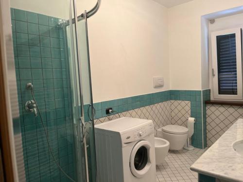 a bathroom with a washing machine and a toilet at Frank House 2 in Montaquila