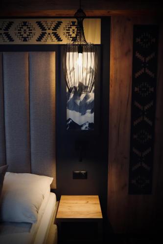 a bedroom with a bed and a light on the wall at Dom Wypoczynkowy u Czerników in Białka Tatrzanska