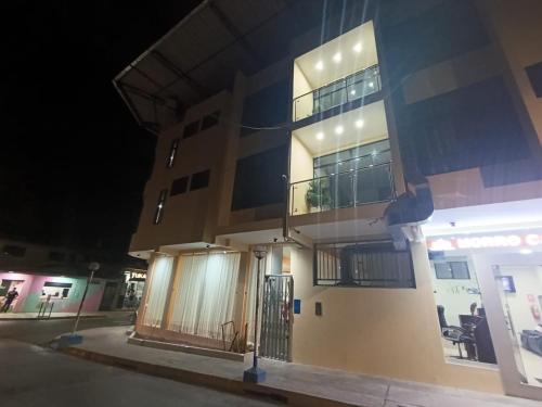 a building with a gate in front of it at night at Morro Calzada in Moyobamba