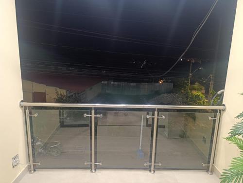 a glass table in a room with a window at Morro Calzada in Moyobamba