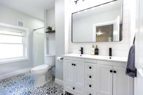 a bathroom with a white sink and a toilet at Jennifer's Elegant & Cozy Broadway Walkable Stay in Providence