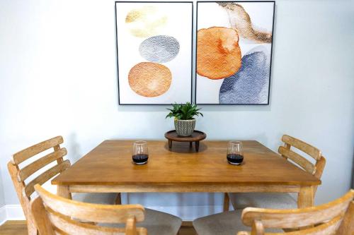 a dining room table with two glasses and a plant on it at Jennifer's Elegant & Cozy Broadway Walkable Stay in Providence