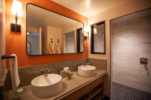 a bathroom with two sinks and a large mirror at Delamar Westport in Westport
