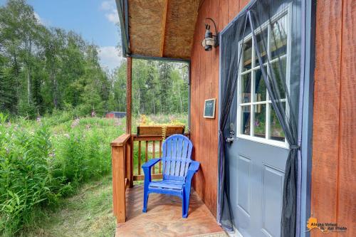 a blue chair sitting on the porch of a house at DFA Cabin Rentals in Talkeetna