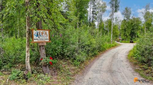 a sign on the side of a dirt road at DFA Cabin Rentals in Talkeetna