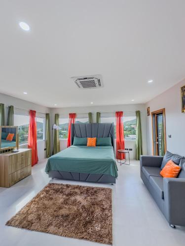 a bedroom with a bed and a couch at Kozmik Sensetionz Suite - 12min from UVF Airport in Vieux Fort