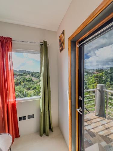a room with a sliding glass door with a view at Kozmik Sensetionz Suite - 12min from UVF Airport in Vieux Fort