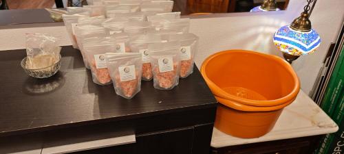 a counter with four plastic containers of food on it at Guest House da Mata2 in Póvoa de Varzim