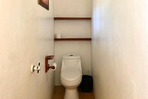 a bathroom with a white toilet in a room at Maracuya Suites Zipolite in Zipolite