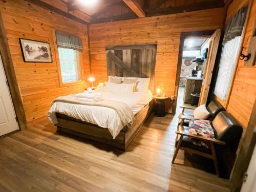 a bedroom with a bed in a room with wooden walls at "Moon Glow" - Cozy Climber Retreat in Muir Valley in Rogers