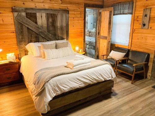 a bedroom with a large bed and a chair at "Moon Glow" - Cozy Climber Retreat in Muir Valley in Rogers