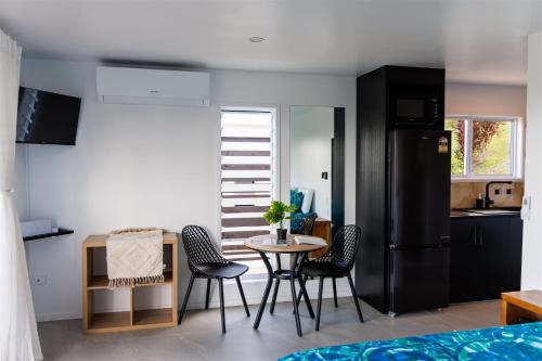 a kitchen with a table and chairs in a room at Muri Ocean View Villas in Ngatangiia