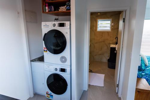two washer and dryer in a small room at Muri Ocean View Villas in Ngatangiia