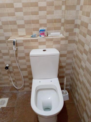 a bathroom with a white toilet in a room at Summer luxury apartments in Mombasa