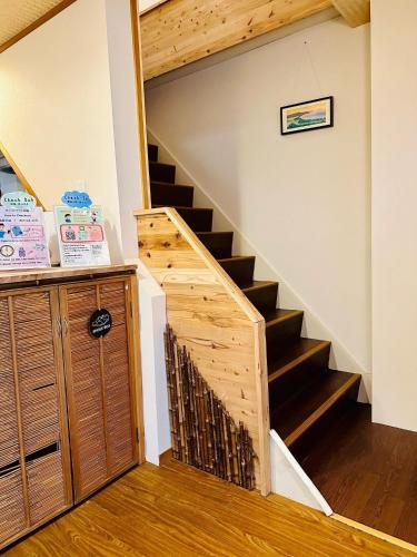 a staircase in a house with a wooden railing at Ikoi no Ie - Vacation STAY 61490v in Kyoto