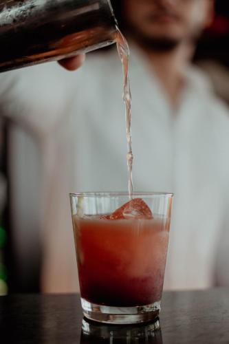 a drink being poured into a glass on a table at L'Hôtel et Restaurant du Golf de Clervaux in Eselborn