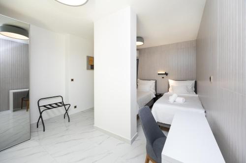 a hotel room with a bed and a chair at Hotel - Teranea City Hvar in Hvar