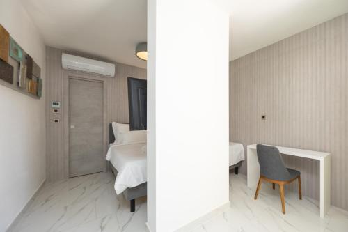 a bedroom with a bed and a desk and a chair at Hotel - Teranea City Hvar in Hvar