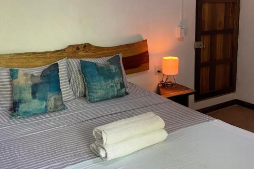 a bedroom with a bed with towels on it at Maracuya Suites Zipolite in Zipolite